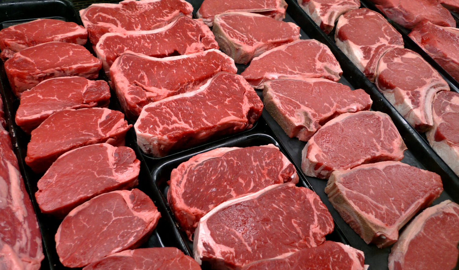 FILE - Steaks and other beef products are displayed for sale at a grocery store in McLean, Va., Jan...
