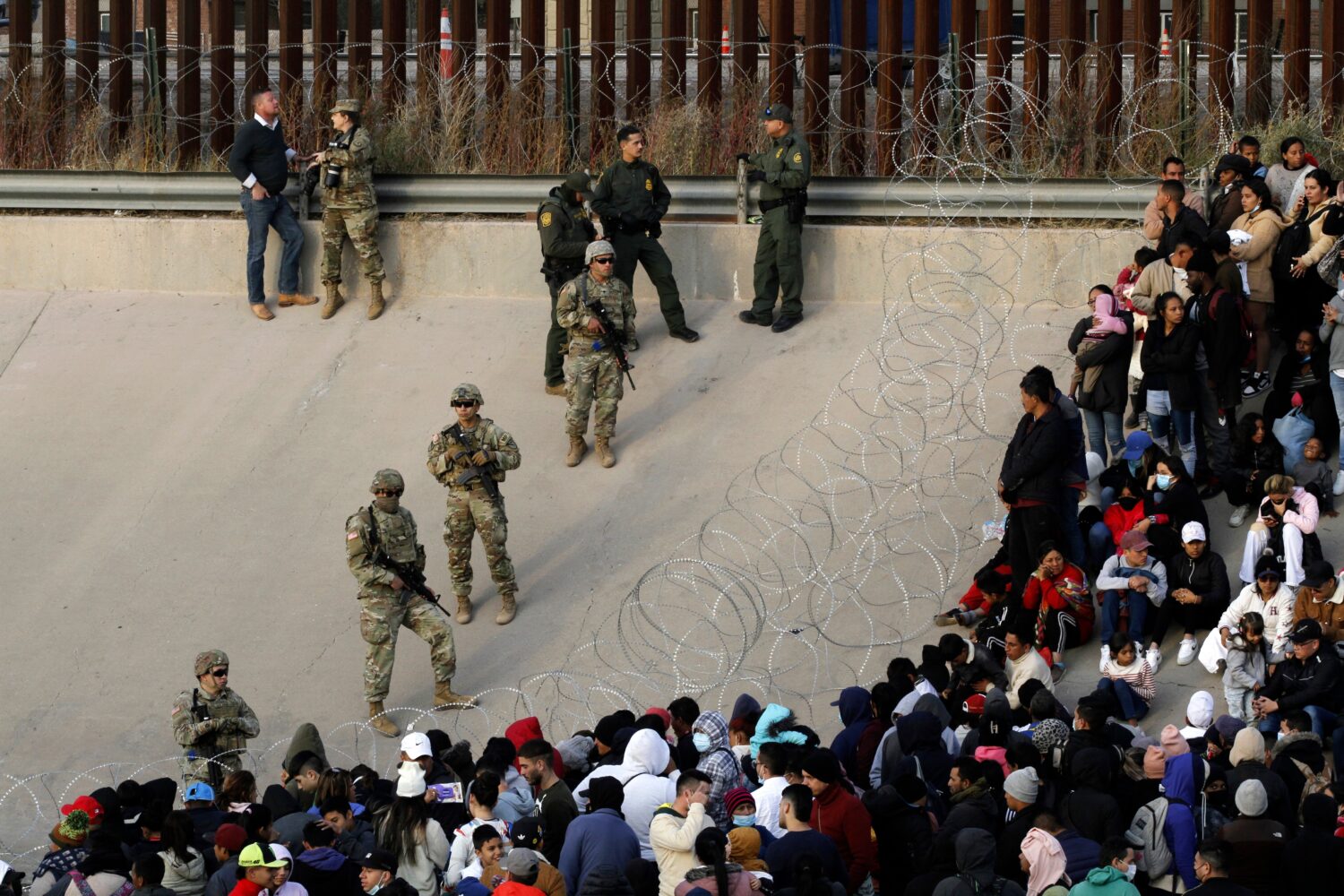 FILE - Migrants congregate on the banks of the Rio Grande at the U.S. border with Mexico on Dec. 20...