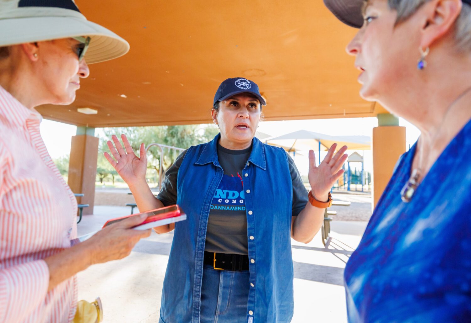 JoAnna Mendoza (D), an Arizona Congressional District 6 candidate, center, talks with campaign volu...