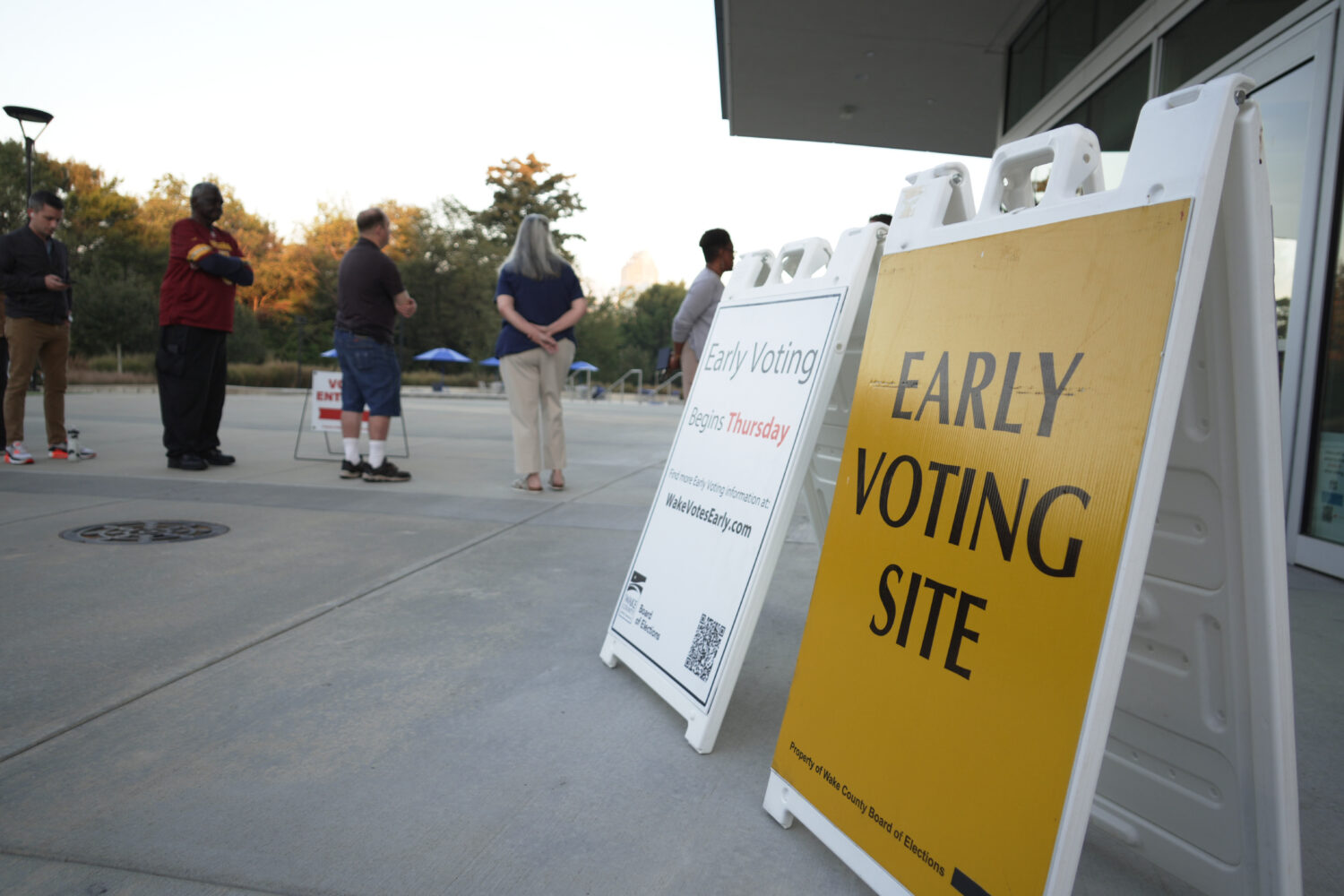 People line up outside the John Chavis Memorial Park center for the first day of early voting in Ra...