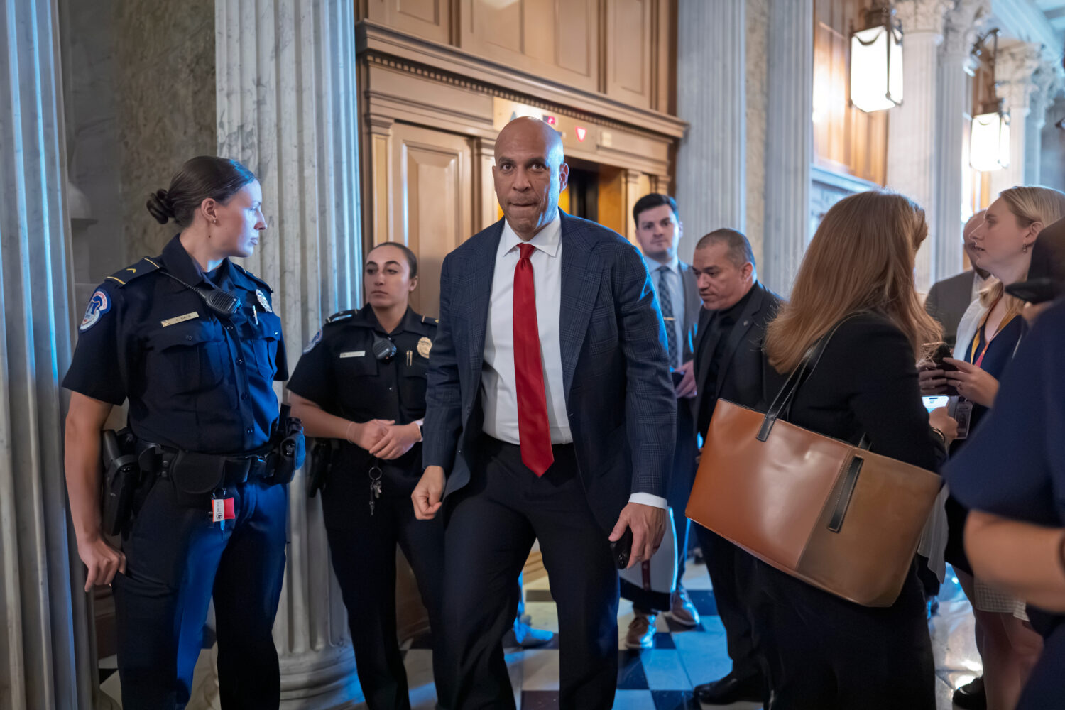 Sen. Cory Booker, D-N.J., walks to the chamber for a vote at the Capitol in Washington, Wednesday, ...