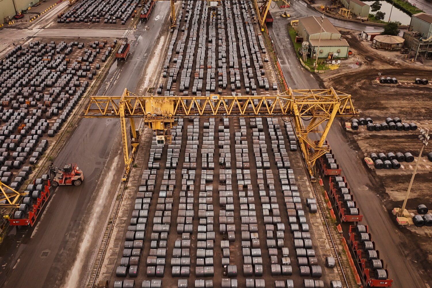 FILE - Rolled coils of steel sit in the yard at the ArcelorMittal Dofasco steel plant in Hamilton, ...