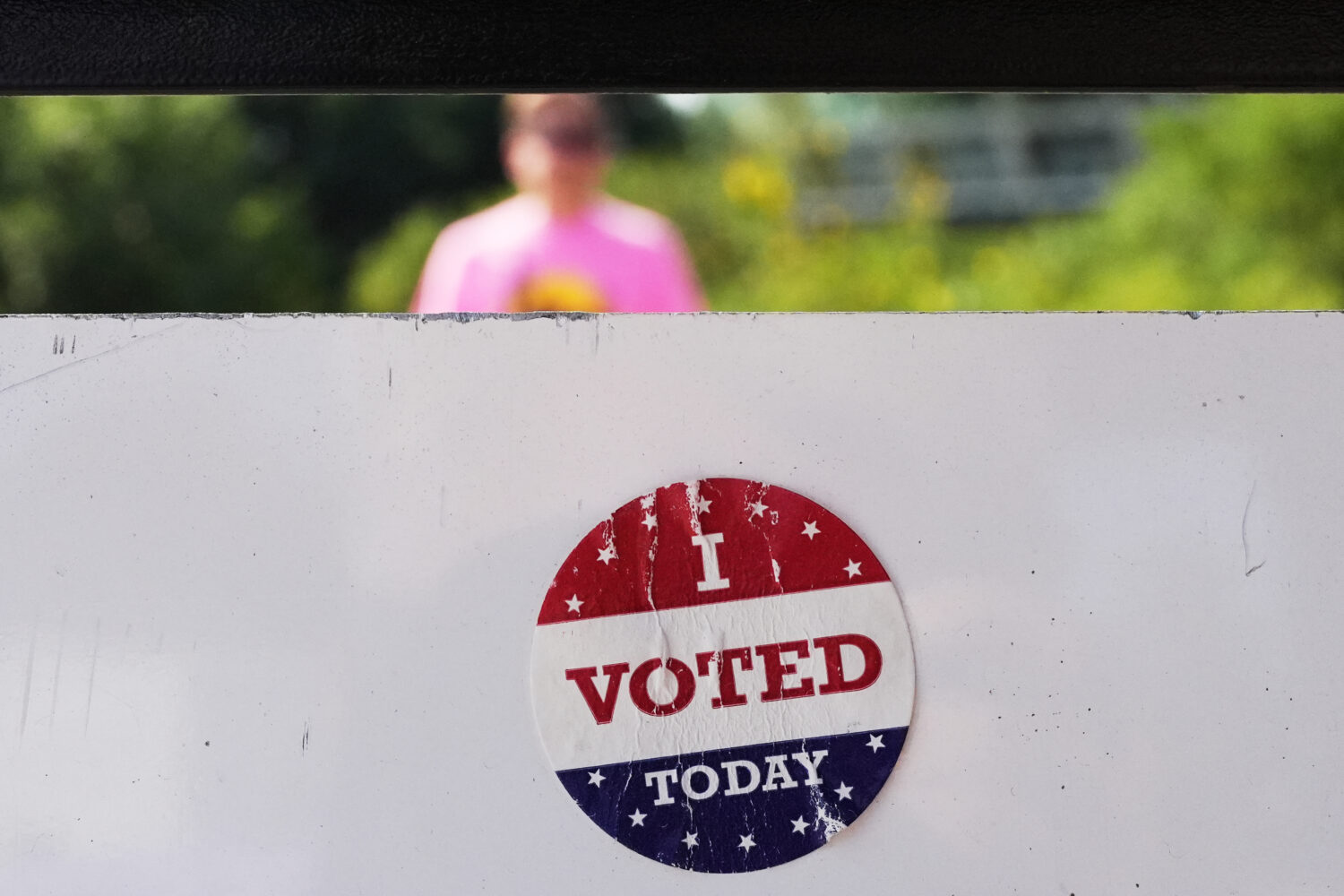 FILE - An, " I Voted Today," sticker is stuck to an information sign at Olbrich Gardens, Aug. 11, 2...