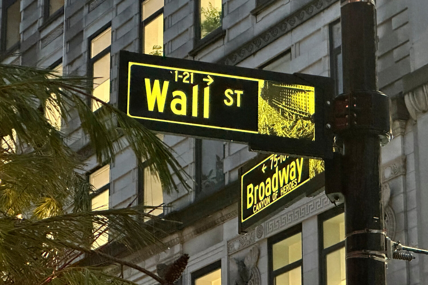 FILE - Signs mark the intersection of Wall Street and Broadway in New York's Financial District on ...