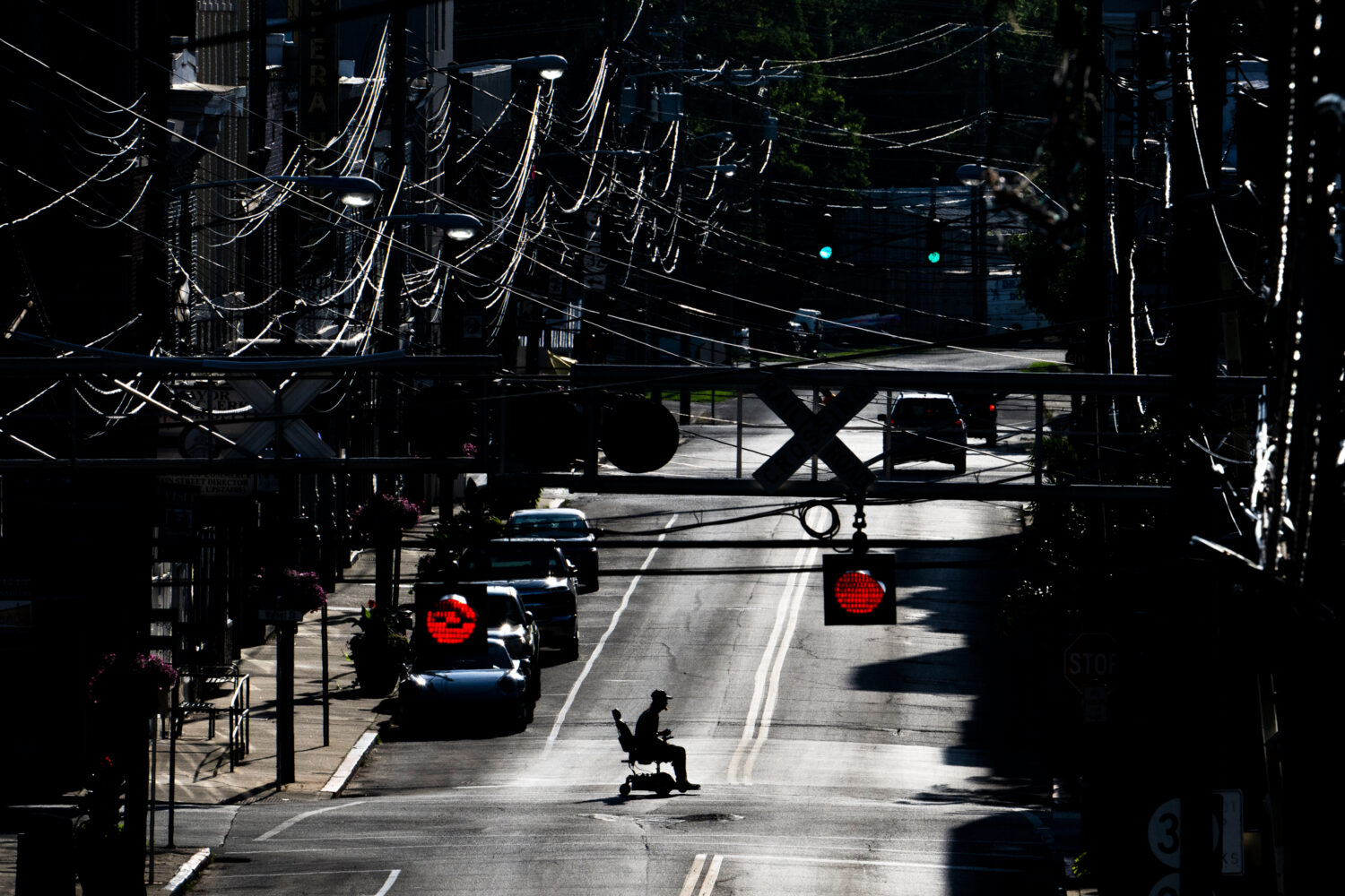FILE - A man in an electric wheelchair crosses Pike Street in downtown Cynthiana, Ky., on June 23, ...