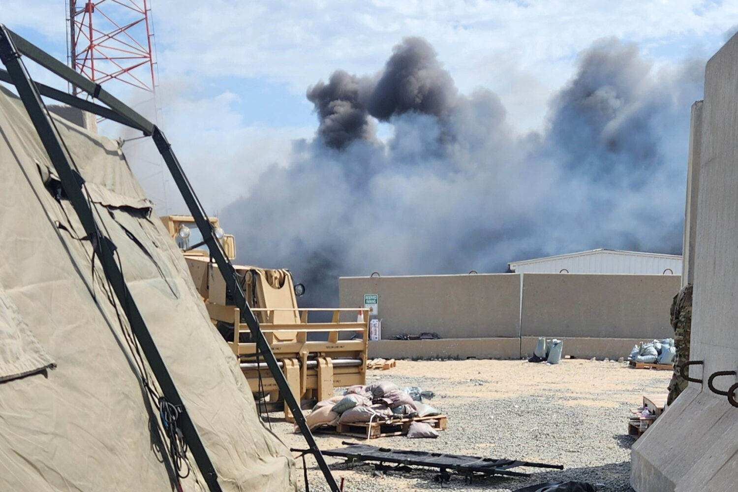In this photo obtained by The Associated Press, smoke rises from an Iranian drone strike at Port Sh...