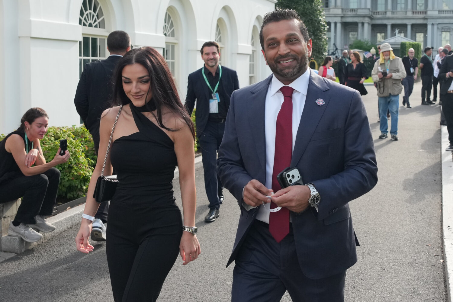 FILE - FBI director Kash Patel, right, and Alexis Wilkins arrive at the White House ahead of the UF...
