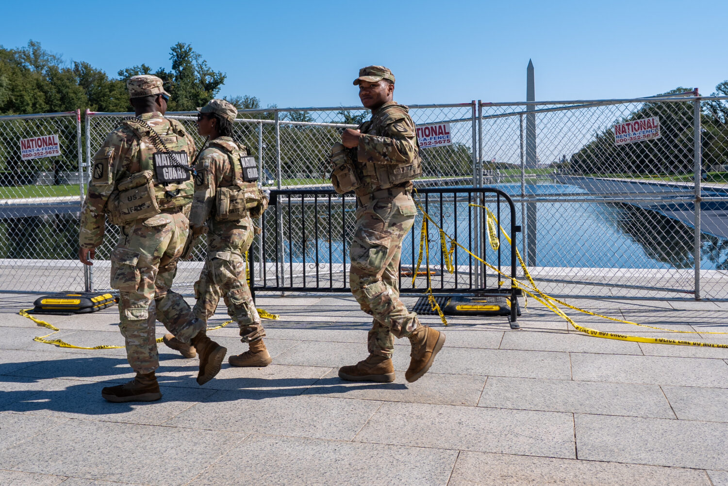 Members of the National Guard walk past the Lincoln Memorial Reflecting Pool, where some water can ...