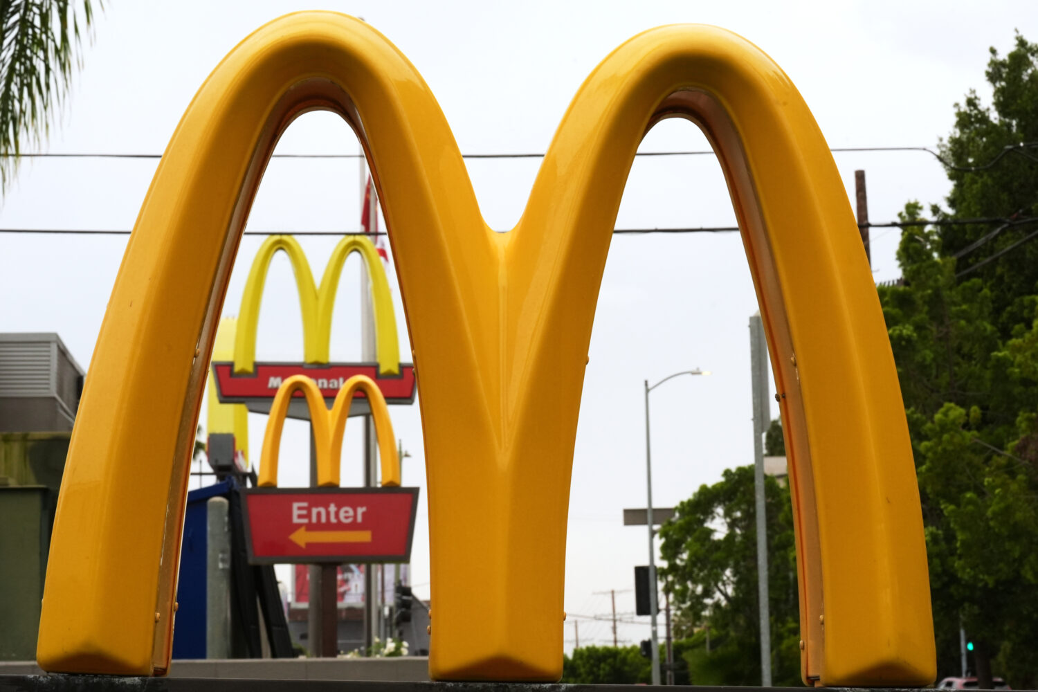 FILE - McDonald's Golden Arches signs are seen, March 31, 2026, in Los Angeles. (AP Photo/Damian Do...