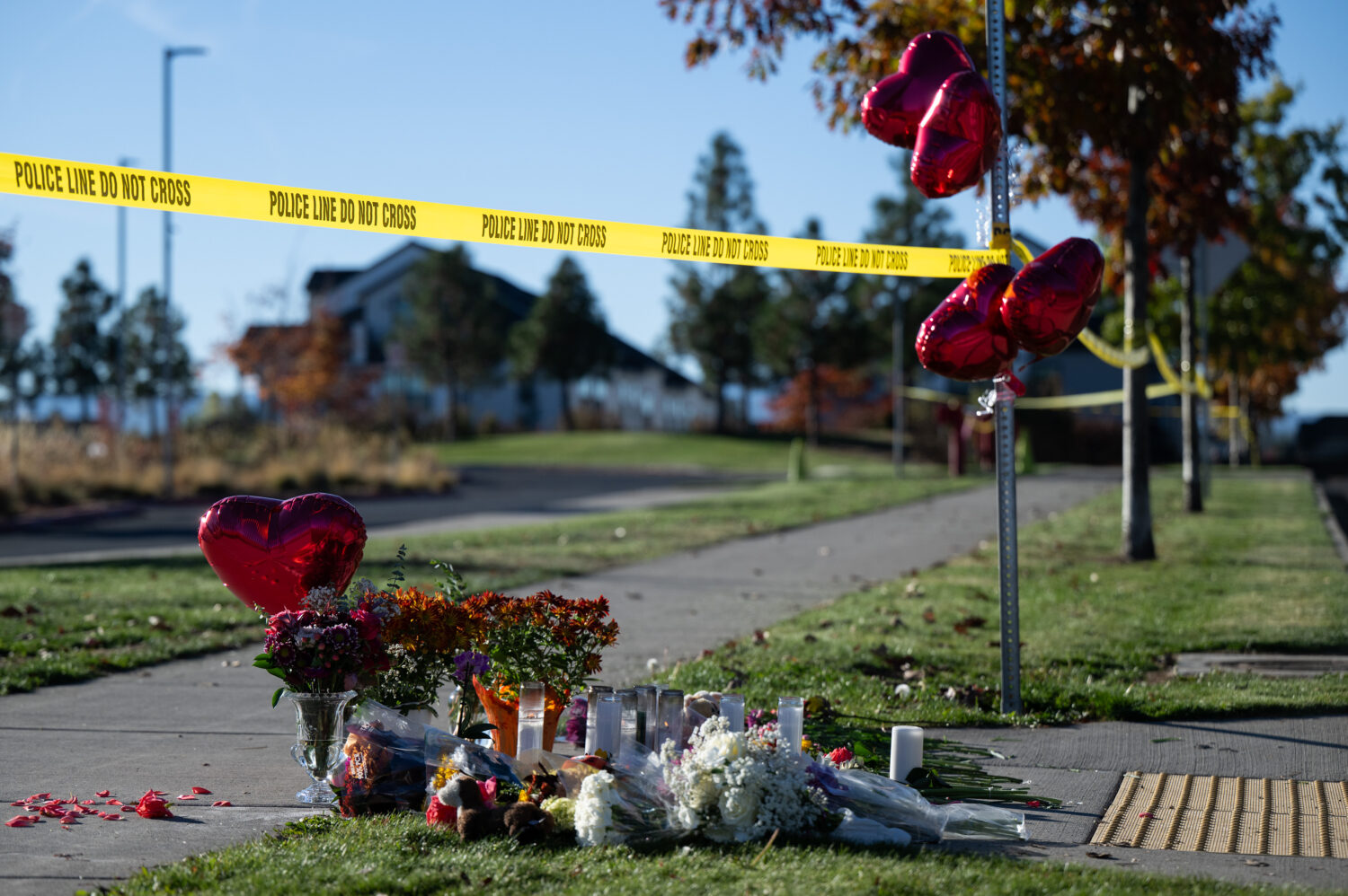 Flowers and candles are seen at a makeshift memorial outside Silver Rail Elementary in Bend, Ore., ...