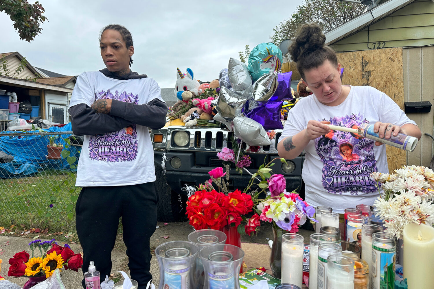 Julius Windham visits a memorial outside the home where authorities say a gunman killed multiple pe...