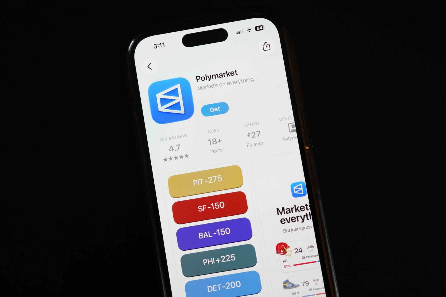 FILE - The prediction market app Polymarket is displayed on a mobile phone, April 16, 2026, in Chic...