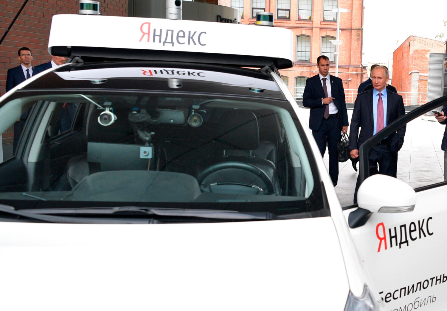 FILE - Russian President Vladimir Putin, right, examines the current prototype of an unmanned vehic...