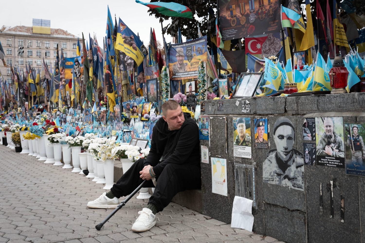 A veteran pays his respects at a makeshift memorial to Ukrainian soldiers killed in the war with Ru...