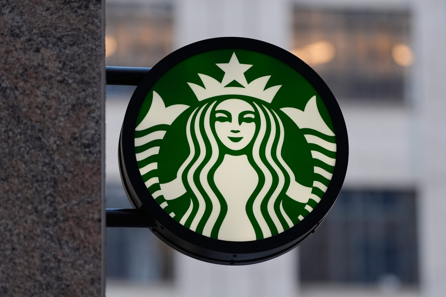 FILE - The Starbucks logo is displayed on a coffee shop, Nov. 24, 2025, in Boston. (AP Photo/Charle...