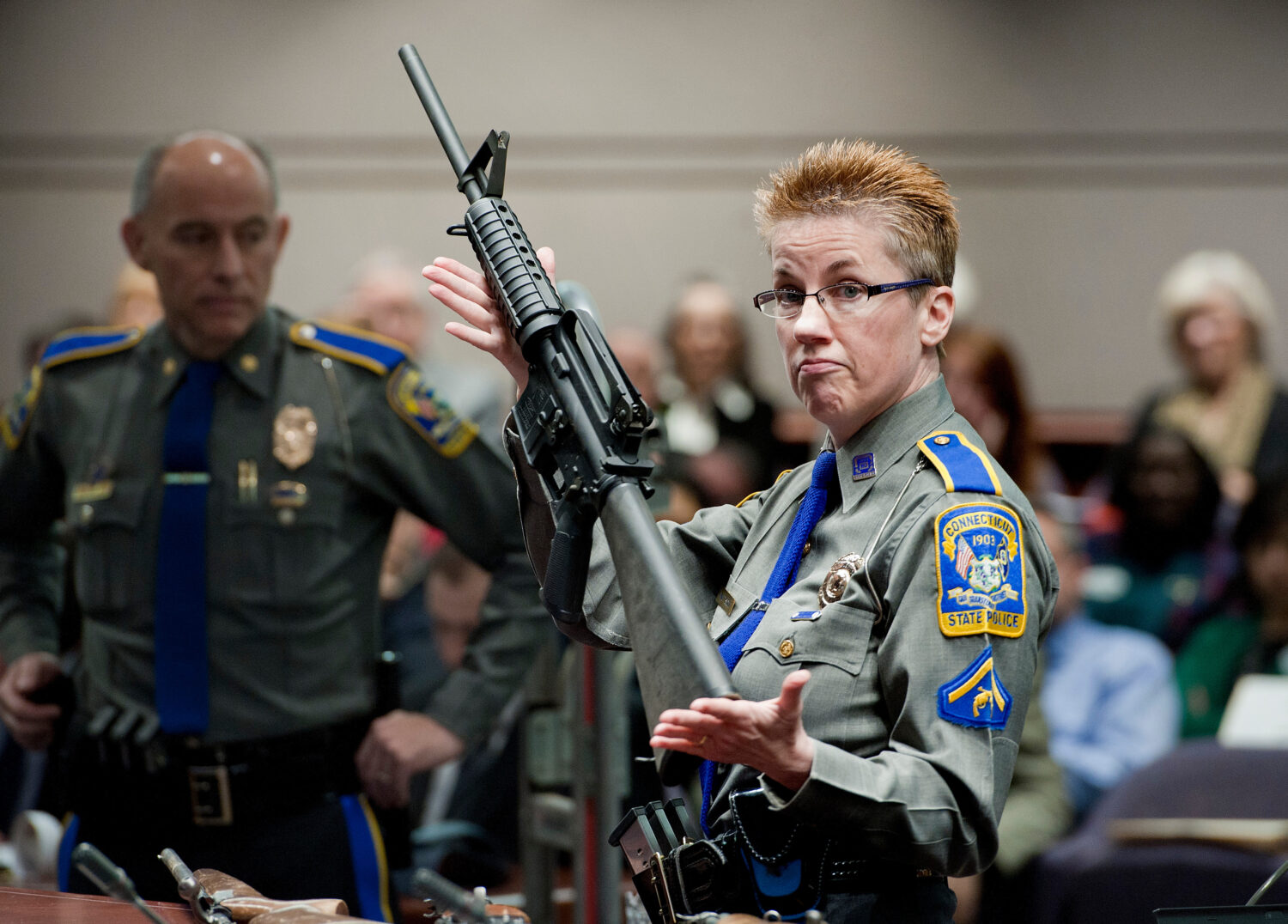 FILE - Firearms training unit Detective Barbara J. Mattson, of the Connecticut State Police, holds ...