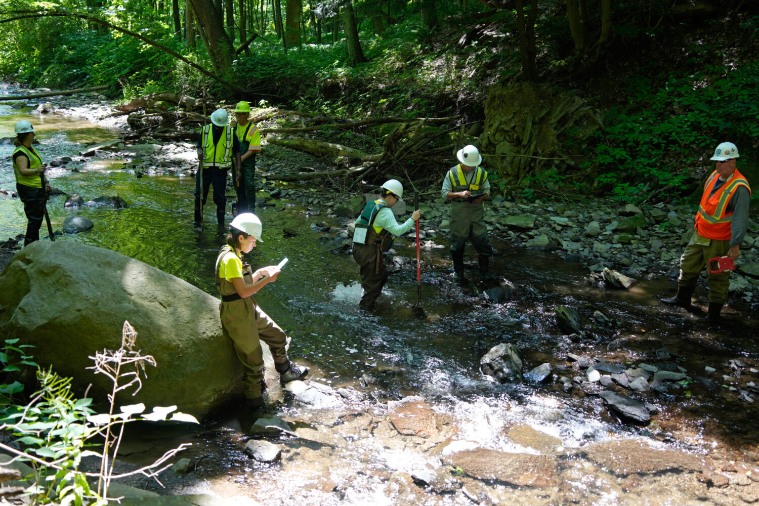 FILE - Environmental Protection Agency workers survey Leslie Run in East Palestine, Ohio, on June 1...