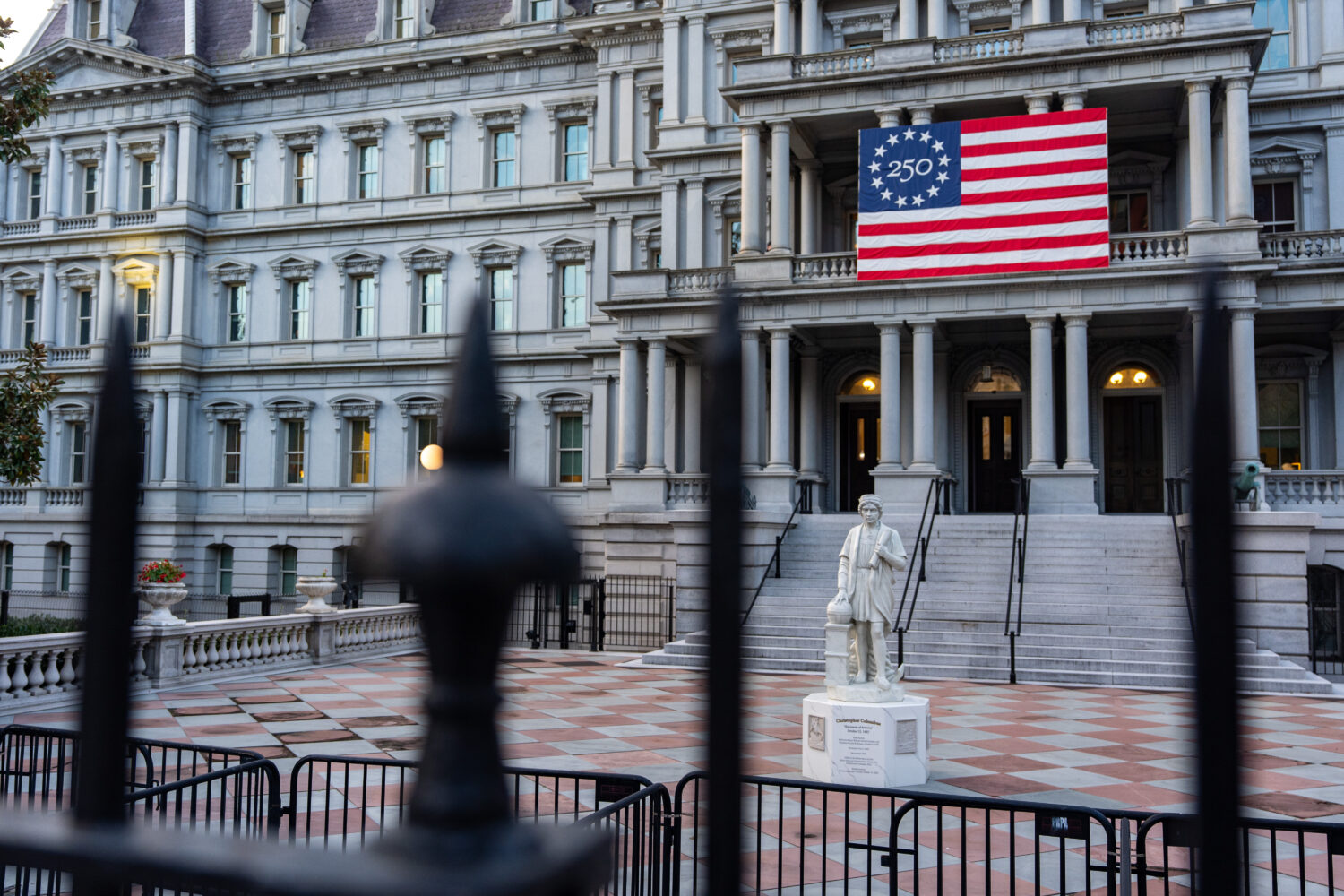 A statue of Christopher Columbus is seen in front of the Eisenhower Executive Office Building on th...
