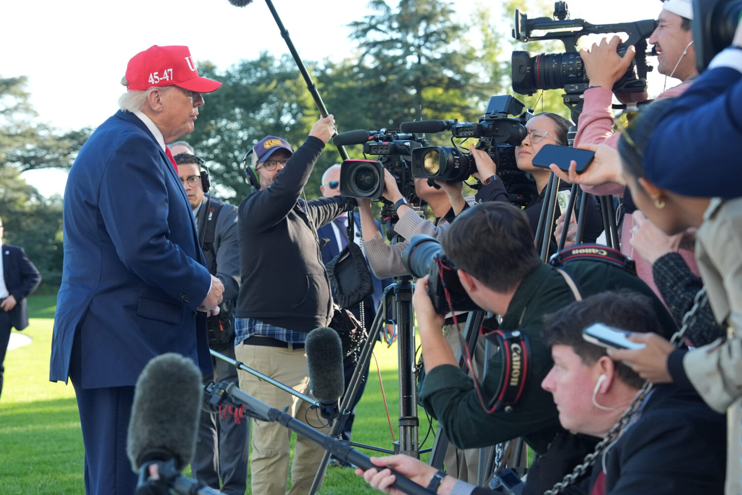 President Donald Trump speaks with reporters after arriving on Marine One from the South Lawn of th...