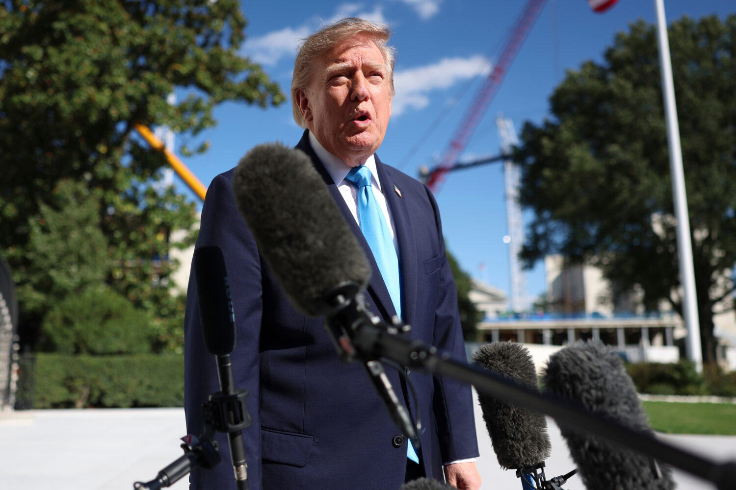 President Donald Trump speaks with reporters before walking to board Marine One on the South Lawn o...