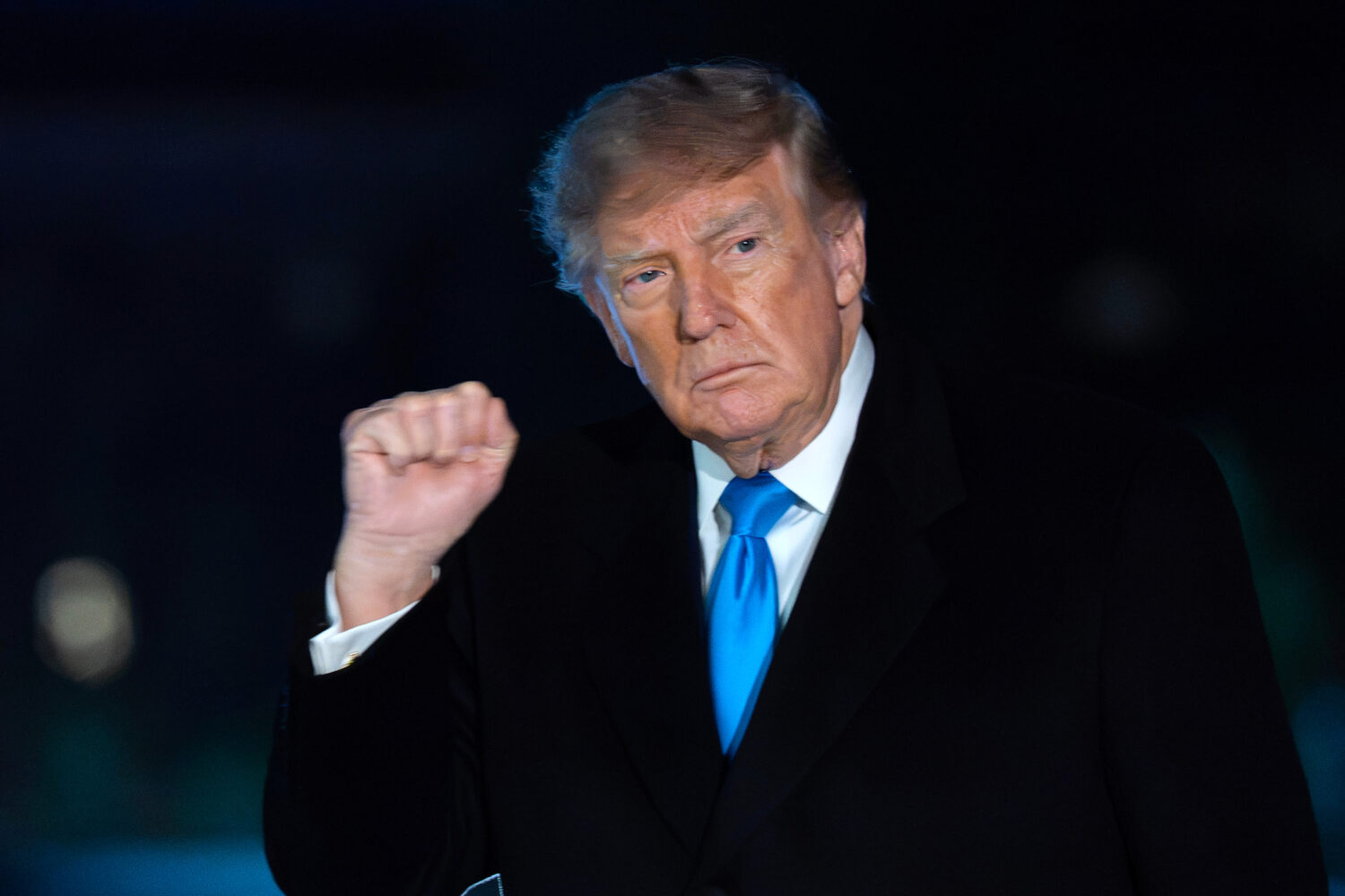 President Donald Trump gestures to reporters as he walks on the South Lawn upon his arrival at the ...