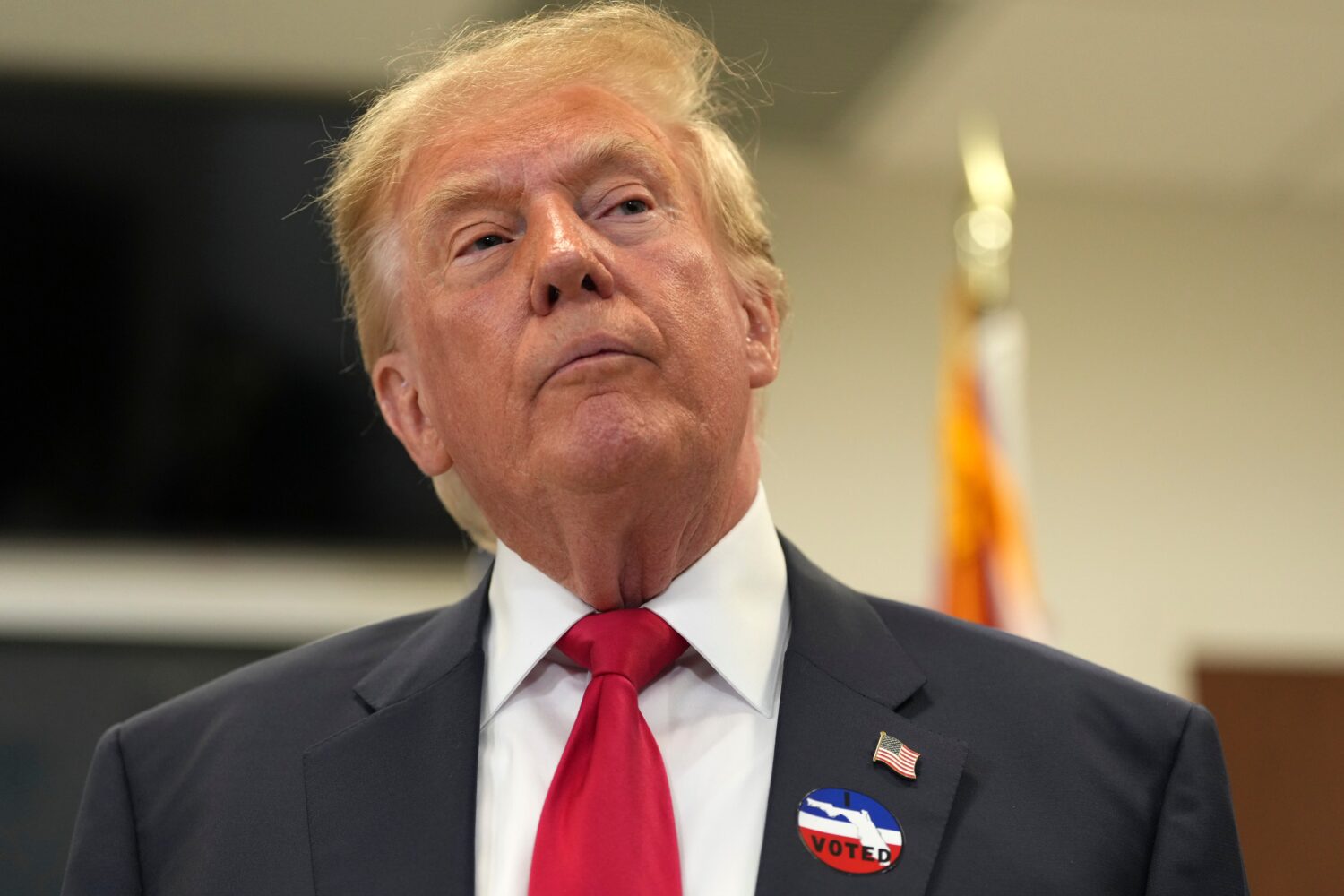 President Donald Trump listens to a question from a reporter after casting his early-voting ballot ...