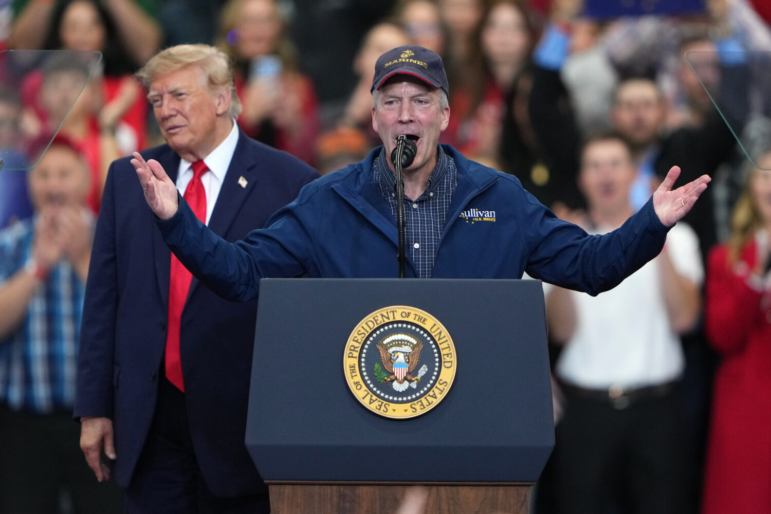 President Donald Trump listens as Sen. Dan Sullivan, R-Alaska, speaks at a campaign rally at the Cu...