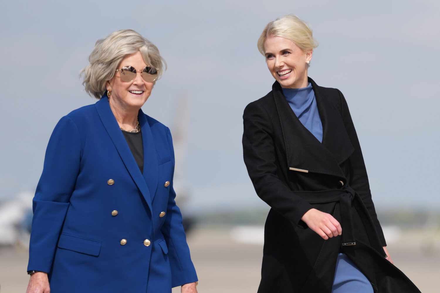 White House chief of staff Susie Wiles and White House aide Natalie Harp walk to board Air Force On...