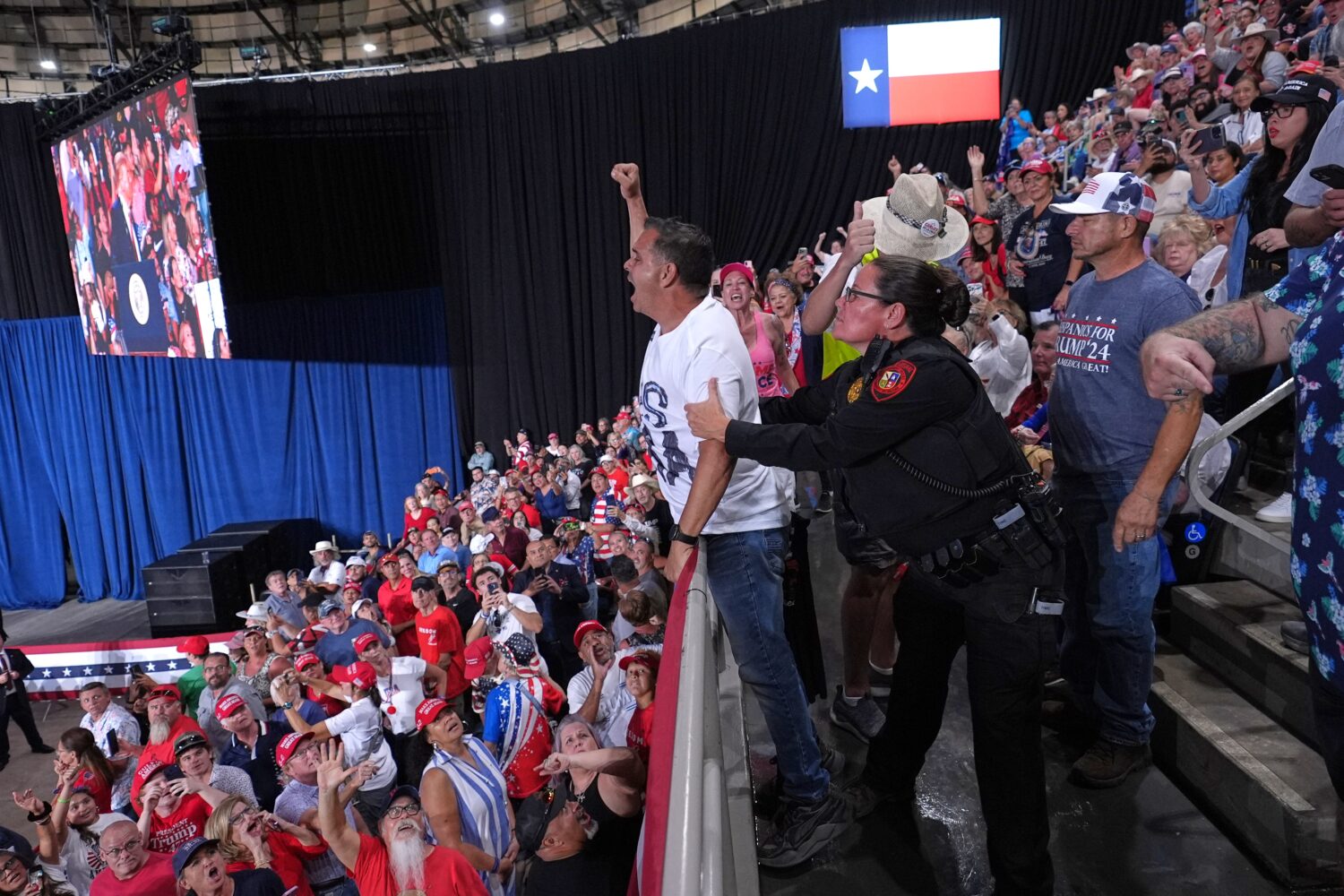 Police remove a protester as President Donald Trump speaks at a campaign rally at the Freeman Colis...