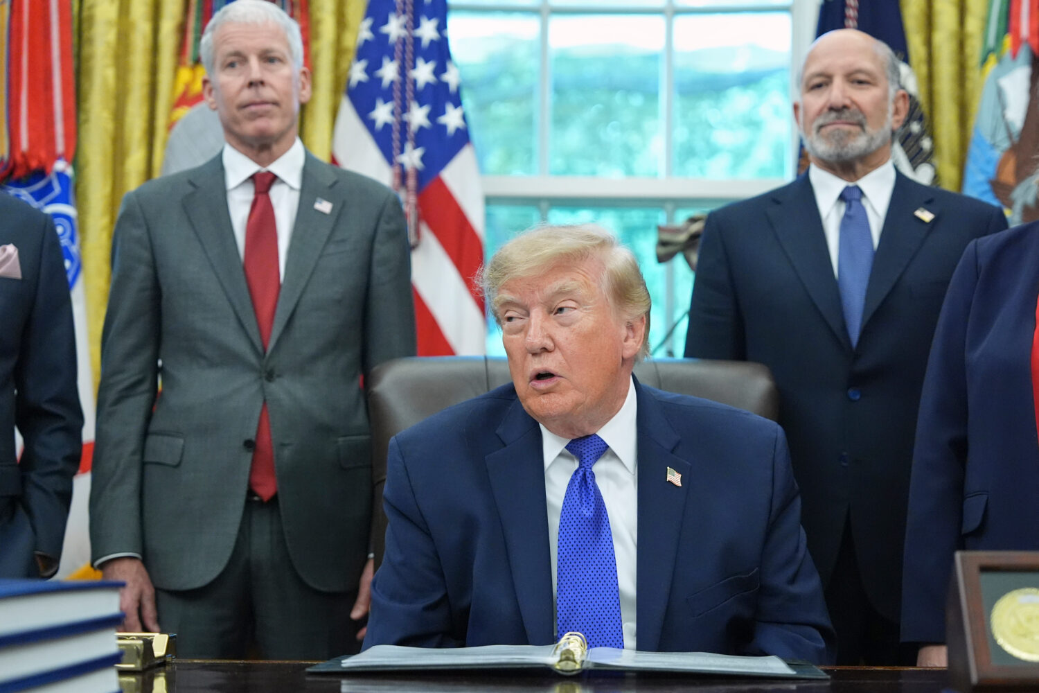 President Donald Trump speaks as Commerce Secretary Howard Lutnick, right, and Energy Secretary Chr...