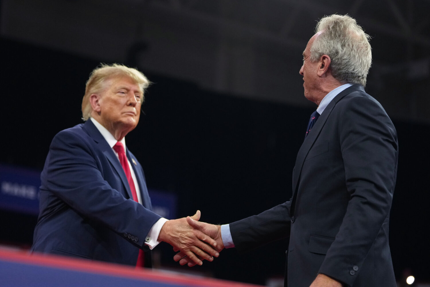 President Donald Trump shakes hands with Health and Human Services Secretary Robert F. Kennedy Jr. ...