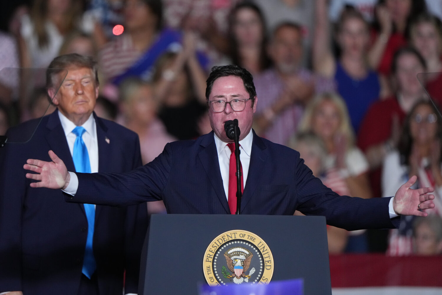 President Donald Trump listens as Rep. Mike Flood, R-Neb., speaks at a campaign rally at the Pinnac...