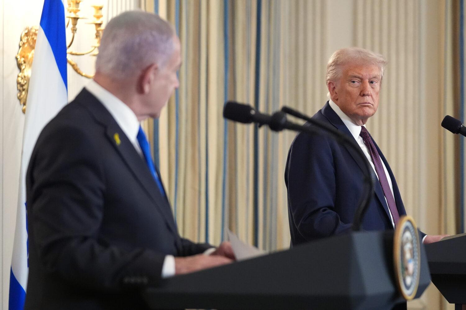FILE - President Donald Trump, right, listens during a news conference with Israeli Prime Minister ...