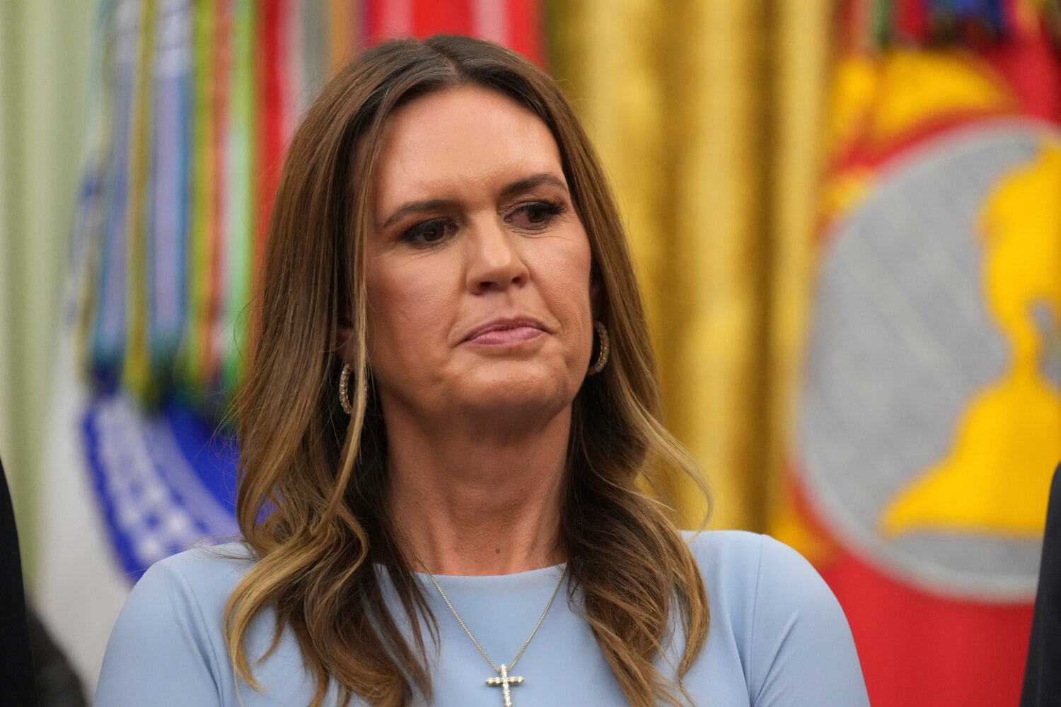 Arkansas Gov. Sarah Huckabee Sanders listens as President Donald Trump speaks during an event about...