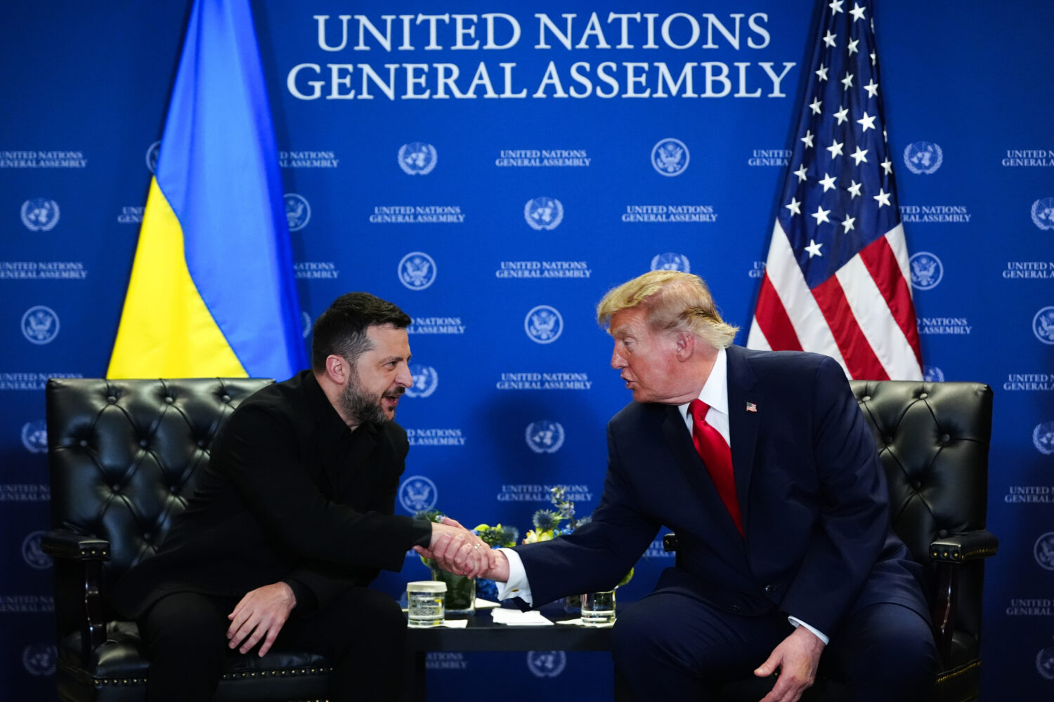President Donald Trump and Ukraine's President Volodymyr Zelenskyy shake hands while meeting during...