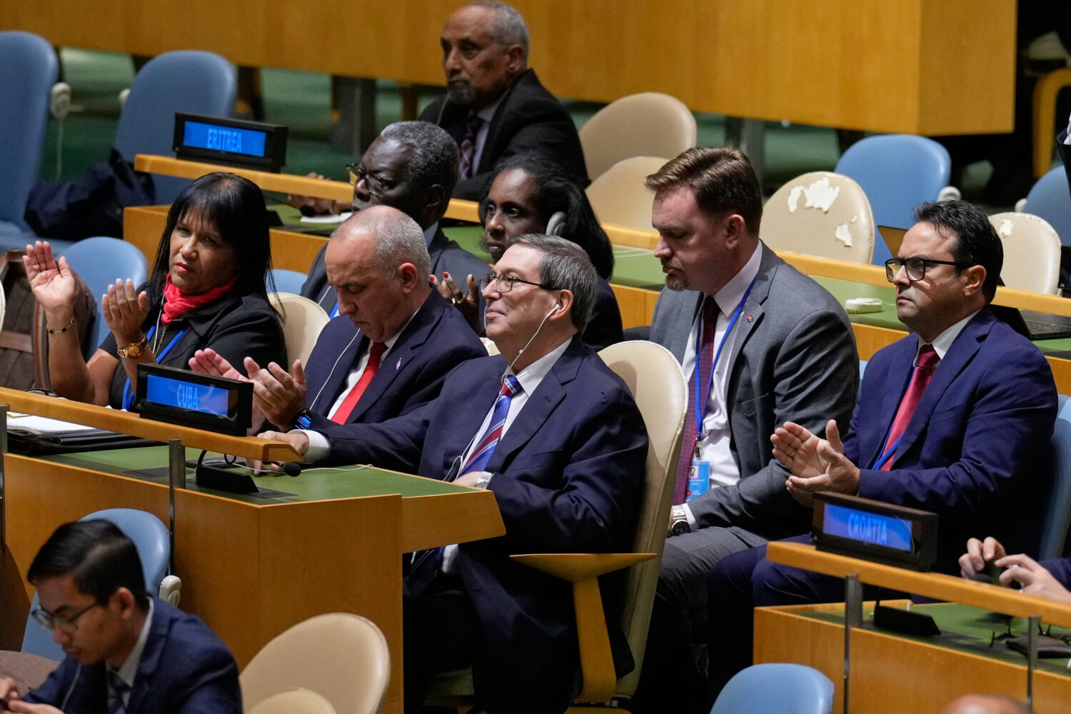 The Cuban delegation, including Cuban foreign minister Bruno Rodriguez Parrilla, center, reacts aft...