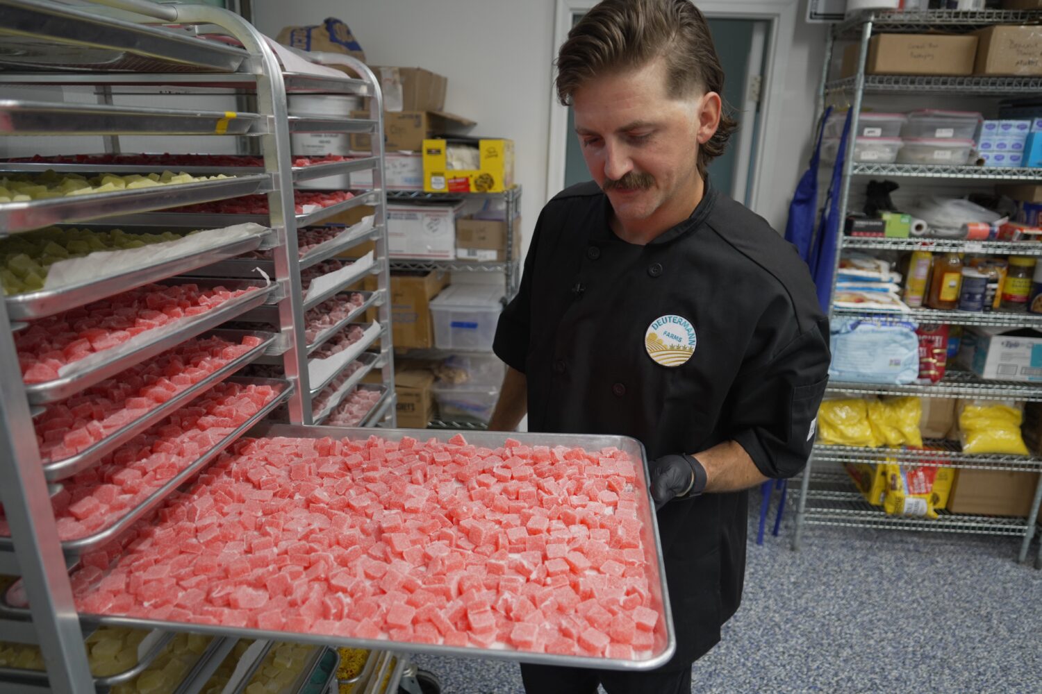 Nicholas Hohns shows off a tray of strawberry-lemon CBD gummies at his Deutermann Farms kitchen in ...