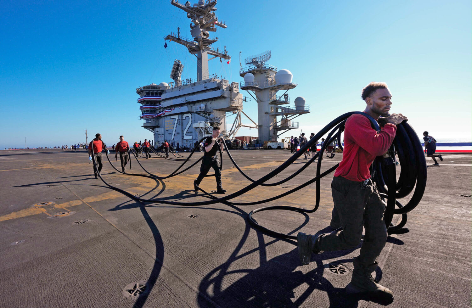 Crew members prepare the U.S.S. Abraham Lincoln (CVN 72) for return on Wednesday, Oct. 7, 2026, to ...