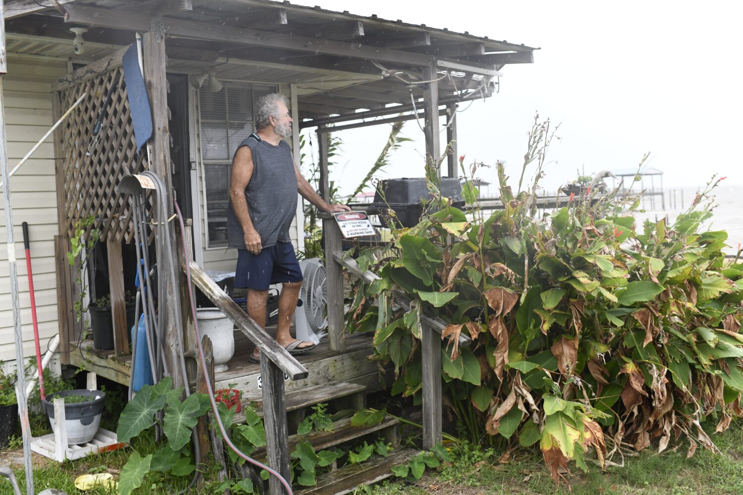 Jim McKenzie looks out over an empty beach as the effects of Isaias keep beachgoers away on Friday,...