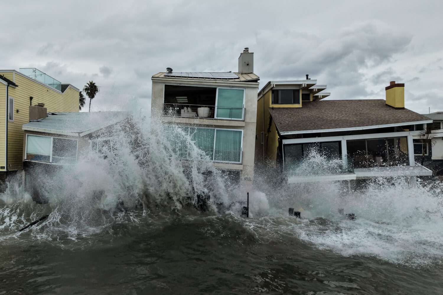Waves from post-tropical cyclone Rachel crash into beachfront homes in Long Beach, Calif., Monday, ...