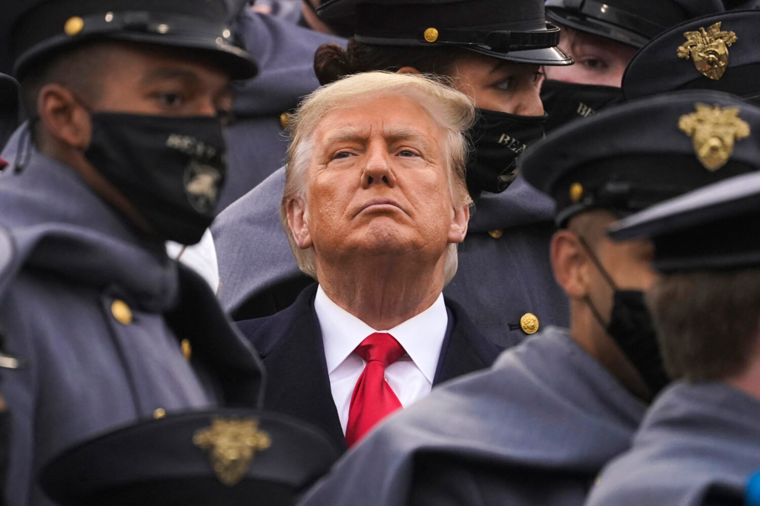 FILE - Surrounded by Army cadets, President Donald Trump watches the first half of the 121st Army-N...