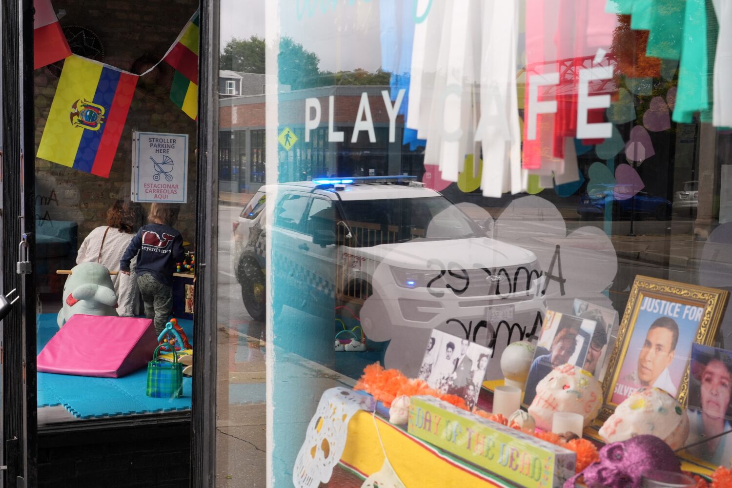 FILE - A Chicago Police Department car is reflected in the window of Luna y Cielo Play Cafe, where ...