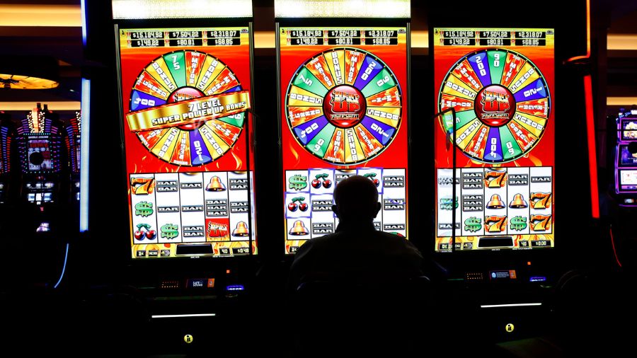 A person sits at the slot machines on the casino floor. (Photo: Octavio Jones, Getty Images)...