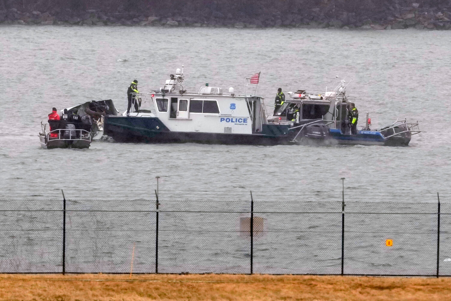 FILE - Search efforts are seen around a wreckage site of a deadly midair collision between an Ameri...