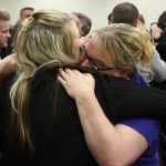 Jayme Biendl's sisters hug in court after a jury recommends their sister's killer be put to death.