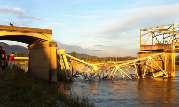 The north end of the Interstate 5 bridge crossing the Skagit River lies collapsed in the water Frid...