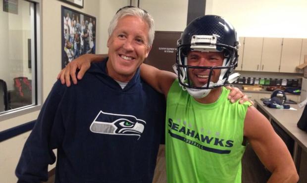 Kenny Chesney poses with Seahawks coach Pete Carroll in Renton on Friday. Chesney plays at CenturyL...