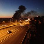 Smoke from a massive Lake Union boatyard fire is seen from I-5 in Seattle Thursday night. (Erynn Rose/KIRO Radio photo)