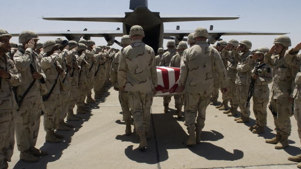 In this Aug. 3, 2003 file photo, members of the 173rd Airborne Brigade salute the casket of Army Sp...