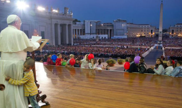 A child embraces Pope Francis as he speaks at St. Peter’s Square. (AP photo)...